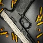 Detailed shot of a Smith & Wesson handgun surrounded by bullet casings.